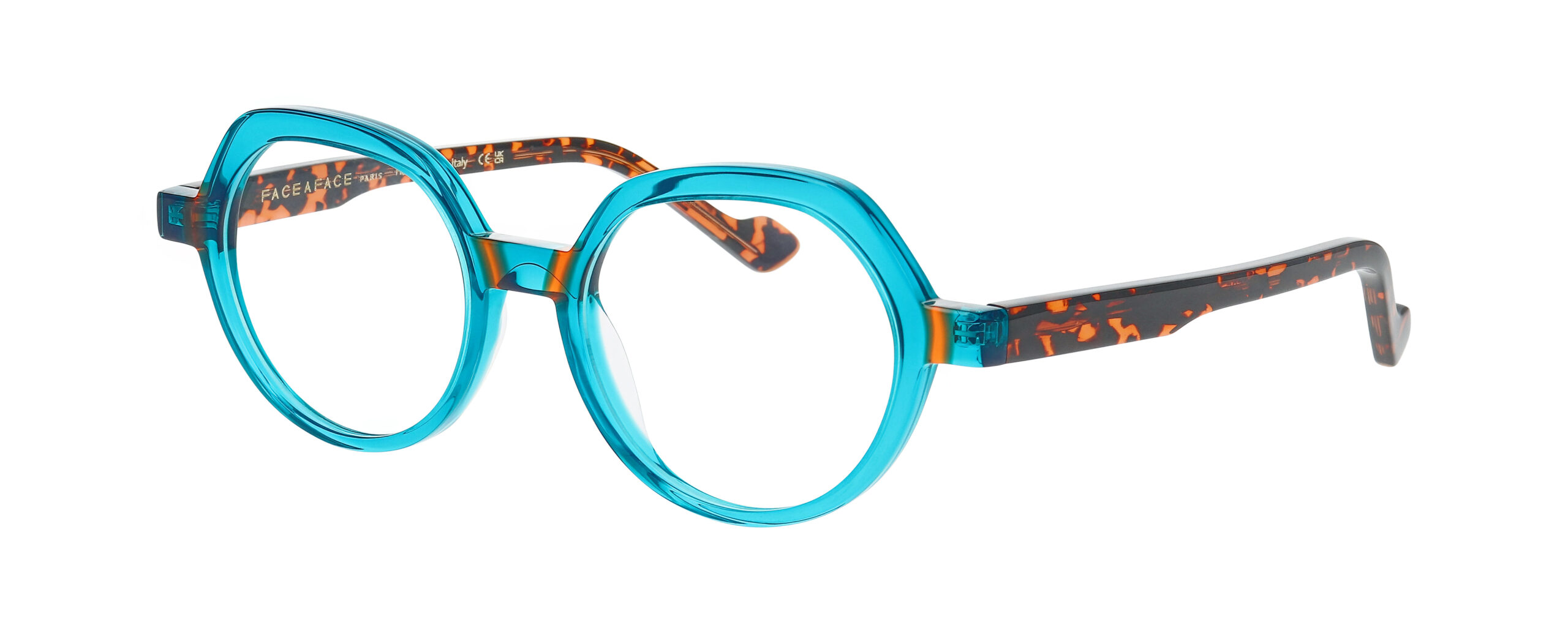 Lunettes de vue FACE A FACE PHOEBE 1 turquoise transparent avec branches écaille marron et orange, photographiées de trois quarts.